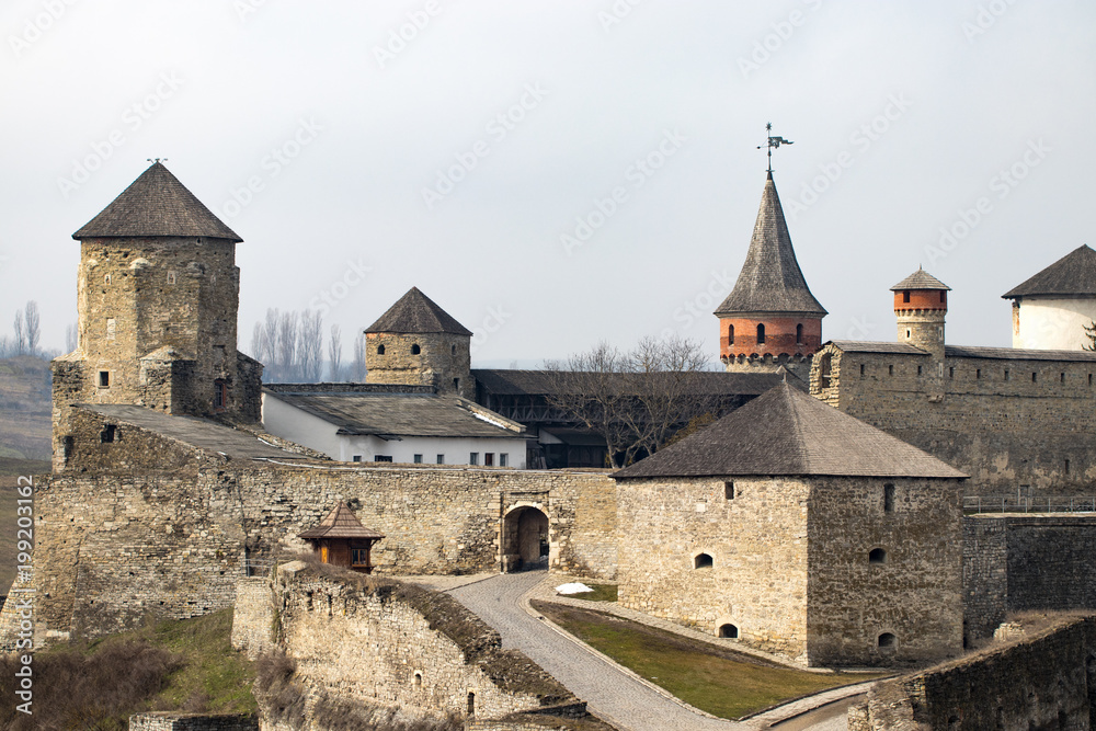 Kamianets Podilskyi fortress built in the 14th century. View of the  fortress wall with towers at early springtime, Ukraine