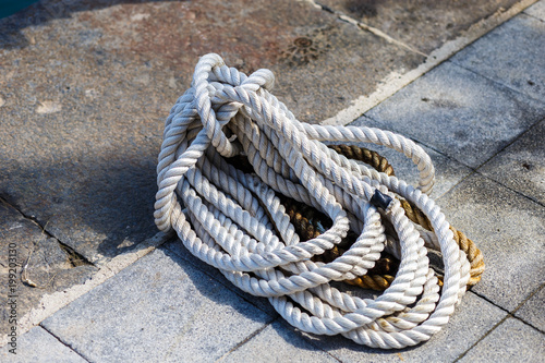 coiled rope on stone marina