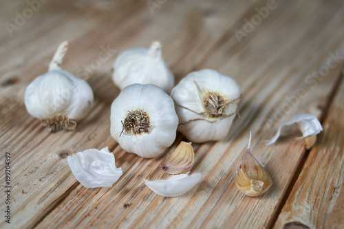 Light wooden background with garlic