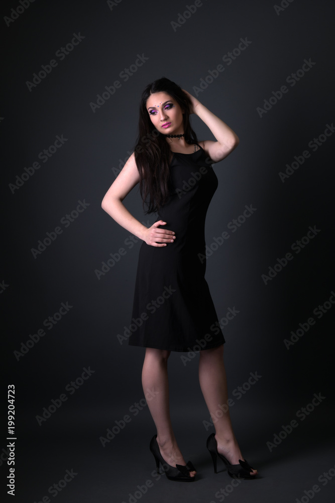 Young arabic woman  isolated on gray background