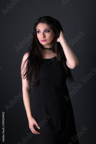Young arabic woman  isolated on gray background