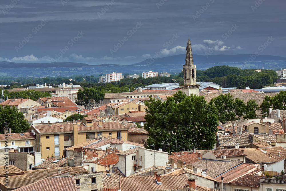 Panorama of the city of Avignon with a bell tower of a medieval church in France.