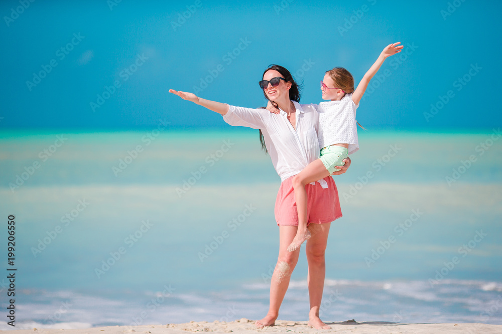 Beautiful mother and daughter on Caribbean beach Beautiful mother and daughter on Caribbean beach