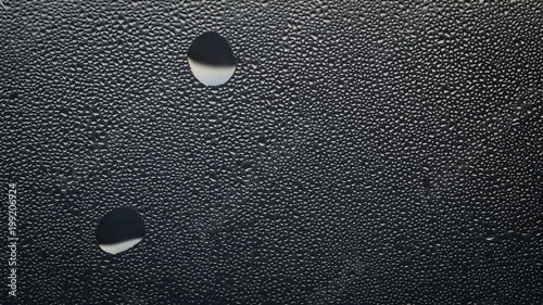 Water drops texture on glass. Abstract minimalistic background for your design. Neutral tone pattern. Aspect ratio 16:9