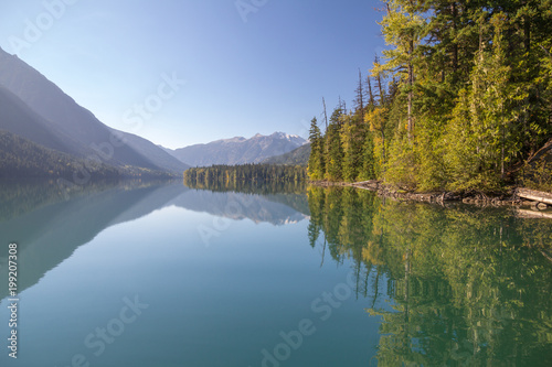 Blue skies, mountains and shoreline reflect perfectly, Birkenhead Lake Park.