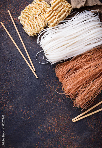 Different Asian rice noodles on rusty background