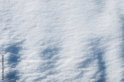 relief of white snow in the mountains in the sun textural background