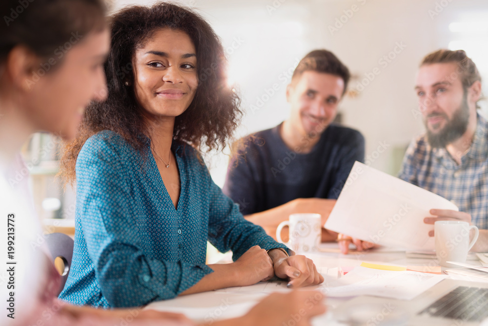 Portrait of a young black woman looking in a work meeting