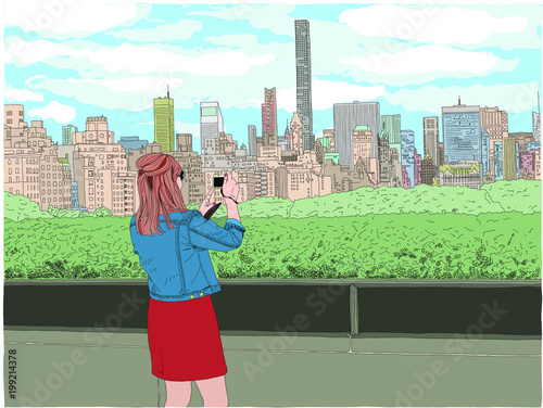 Stylish young woman taking a photo of the Manhattan skyline from a rooftop.