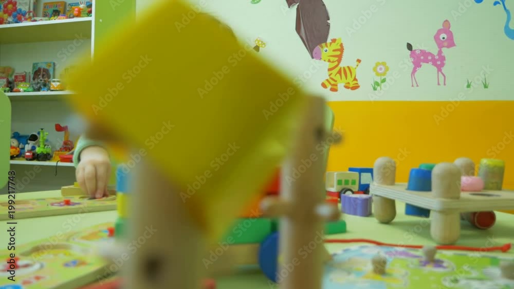 Cute little girl plays in the kindergarten.