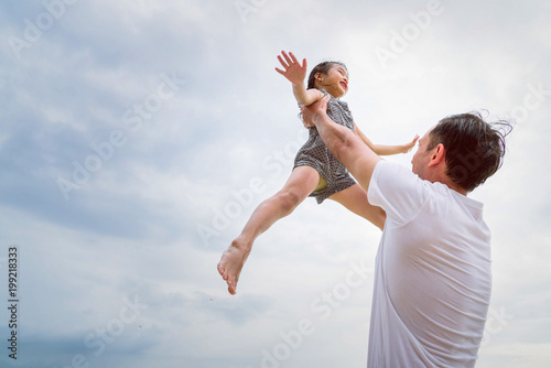 Young father having fun with his daughter