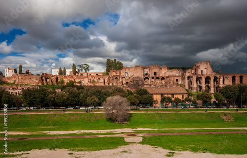 Panoramic view of the Ancient Rome Imperial Palace ruins on Palatine Hill with stormy clouds from Circuss Maximus, in the historic center of Rome © crisfotolux