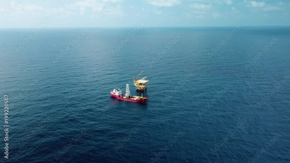 An aerial view from a drone of a soil boring boat (a geotechnical drilling cum analogue survey vessel) close to a oil platform
An aerial view from a drone of a soil boring boat (a geotechnical drilling cum analogue survey vessel) close to a oil platform
