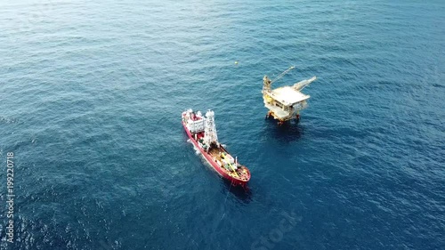 An aerial view from a drone of a soil boring boat (a geotechnical drilling cum analogue survey vessel) close to a oil platform
 photo