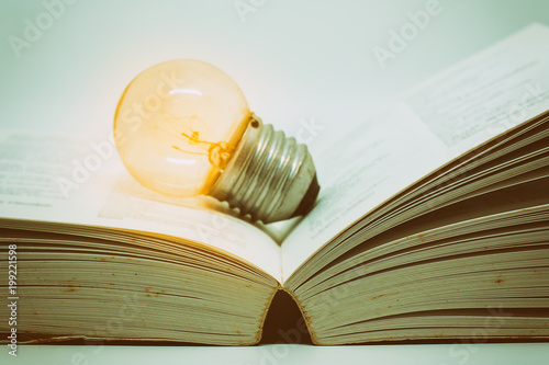 Opened book with glowing li...