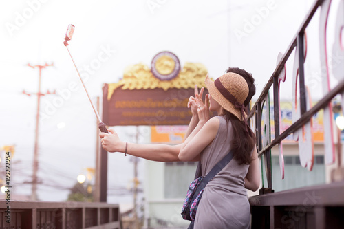 Tourist couple using selfies stick taking piture photo