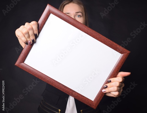 In the hands of a businessman a frame with the inscription: