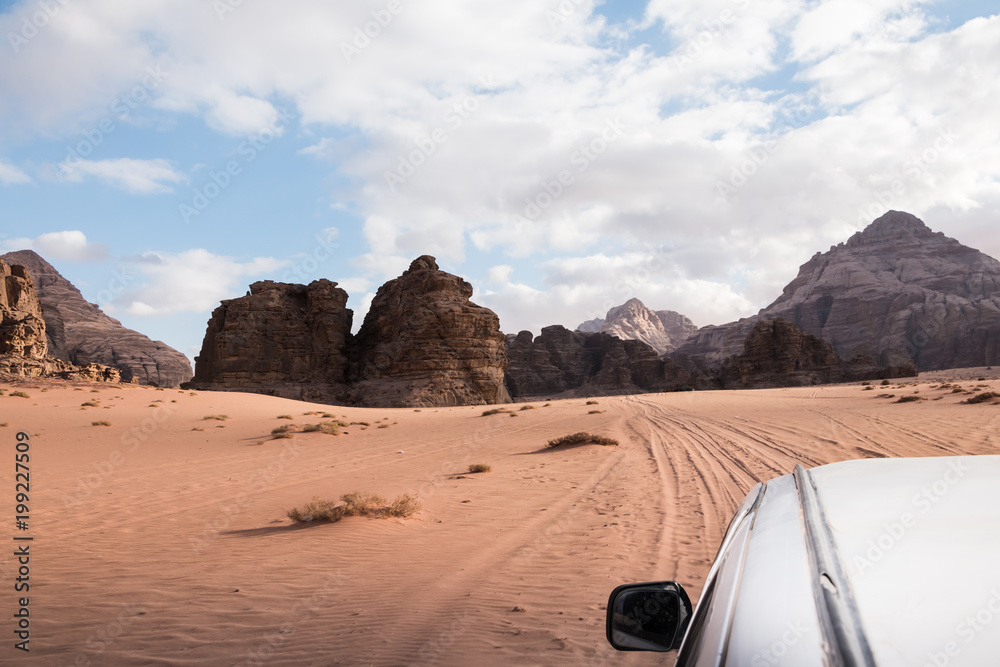 The view from the body of the jeep on beautiful views of sand and large rocks in the Wadi rum desert in Jordan on a evening