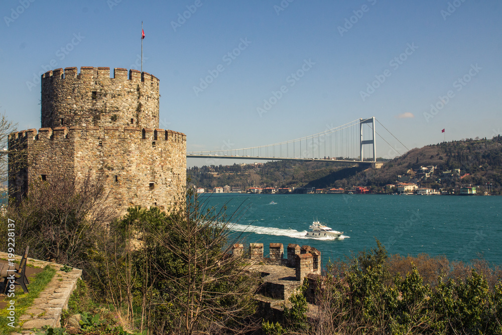Naklejka premium View of the tower of the Rumeli Hisari and the bridge over the Bosphorus in Istanbul. Turkey
