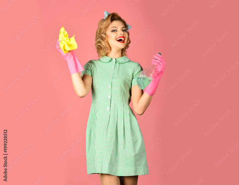 Girl hold in the hands a duster and soap bottle Girl hold in the hands a duster and soap bottle