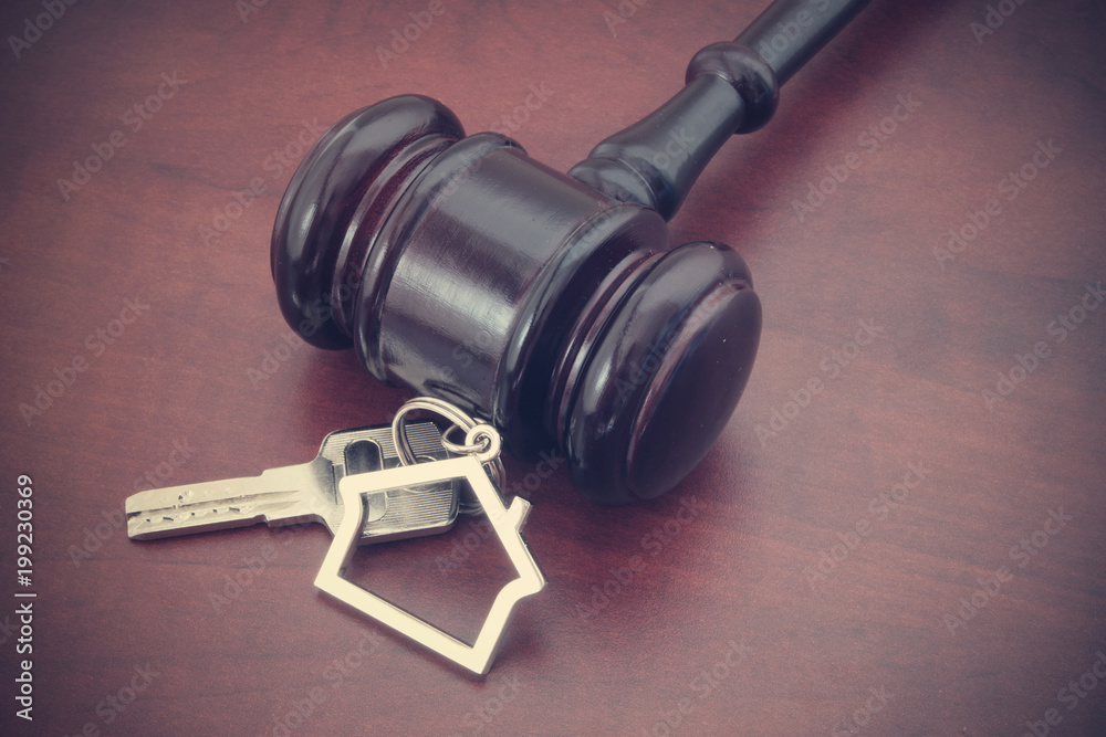 Judge gavel and keys with kechain on wooden table Judge gavel and keys with kechain on wooden table