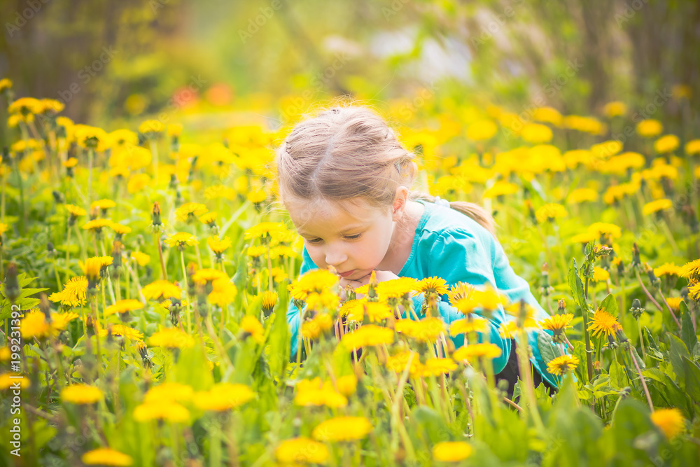 portrait of little girl outdoors in summer.A little blonde caucasian child girl in a dandelio meadow, field full of plants.dandelion yellow flower field portrait of little girl outdoors in summer.A little blonde caucasian child girl in a dandelio meadow, field full of plants.dandelion yellow flower field