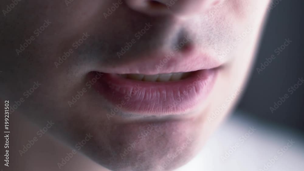 Lips of a man talking. Closeup