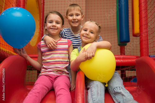 Kids playing in a pool of balls