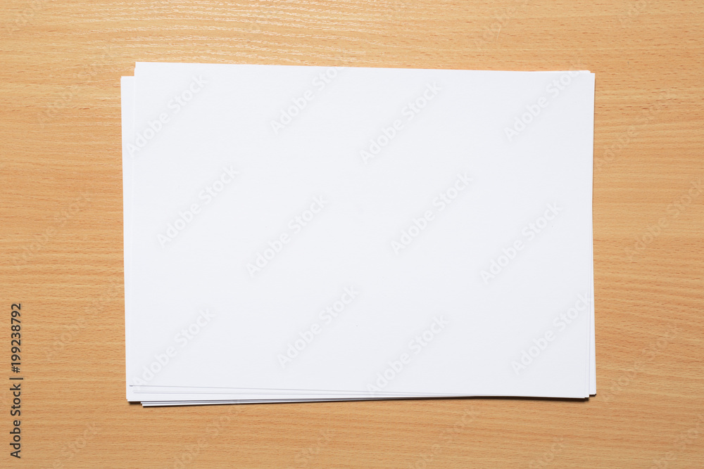 White business card on wooden table. Blank portrait A4. White business card on wooden table. Blank portrait A4.