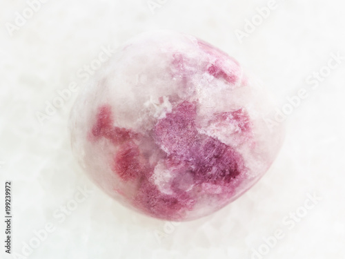 polished pink Sodalite gemstone on white marble