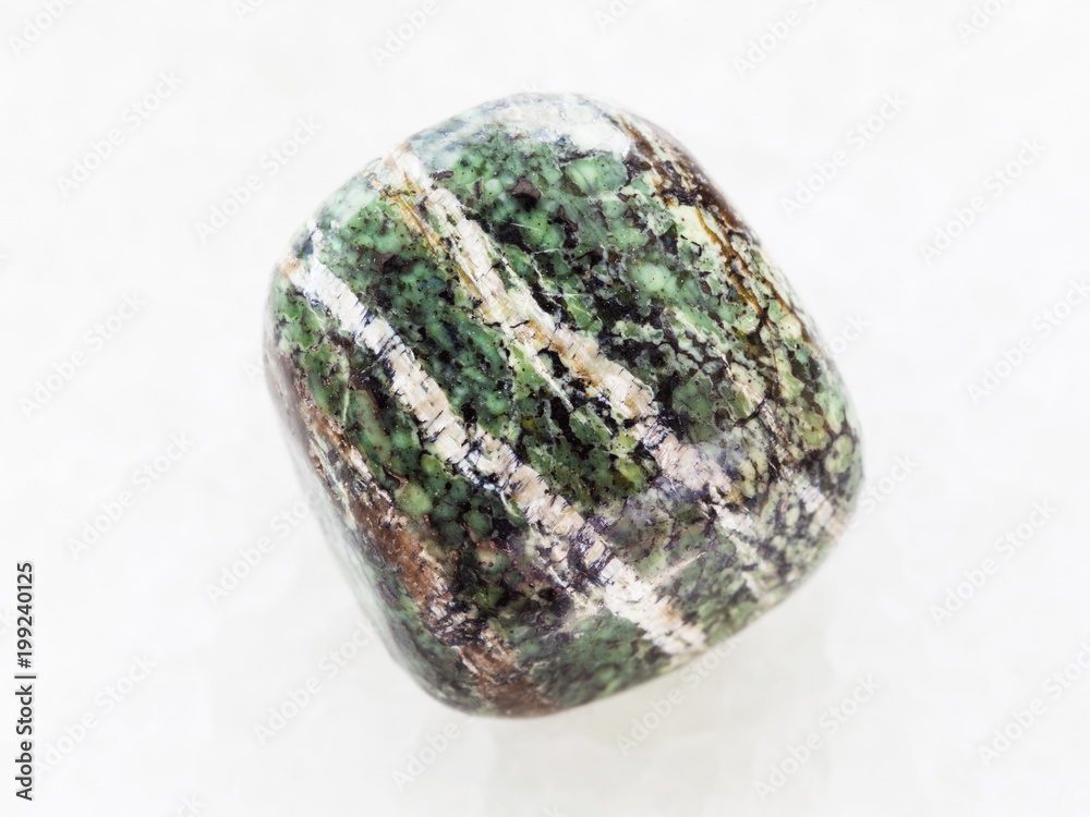 polished chrysotile gemstone on white marble polished chrysotile gemstone on white marble