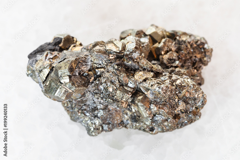 raw pyrite stone on white marble raw pyrite stone on white marble