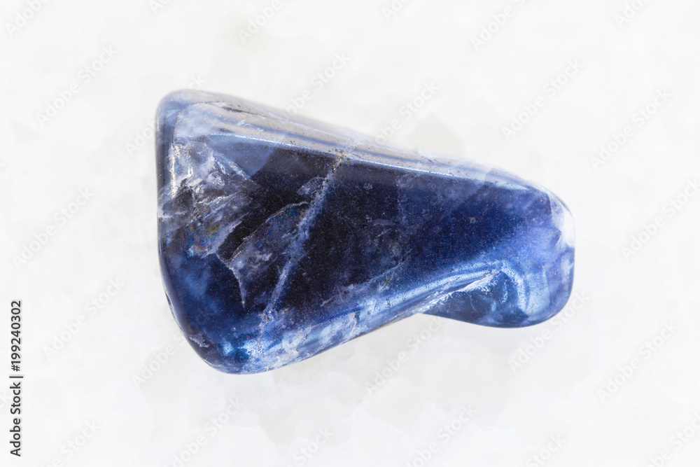 polished Dumortierite gemstone on white marble