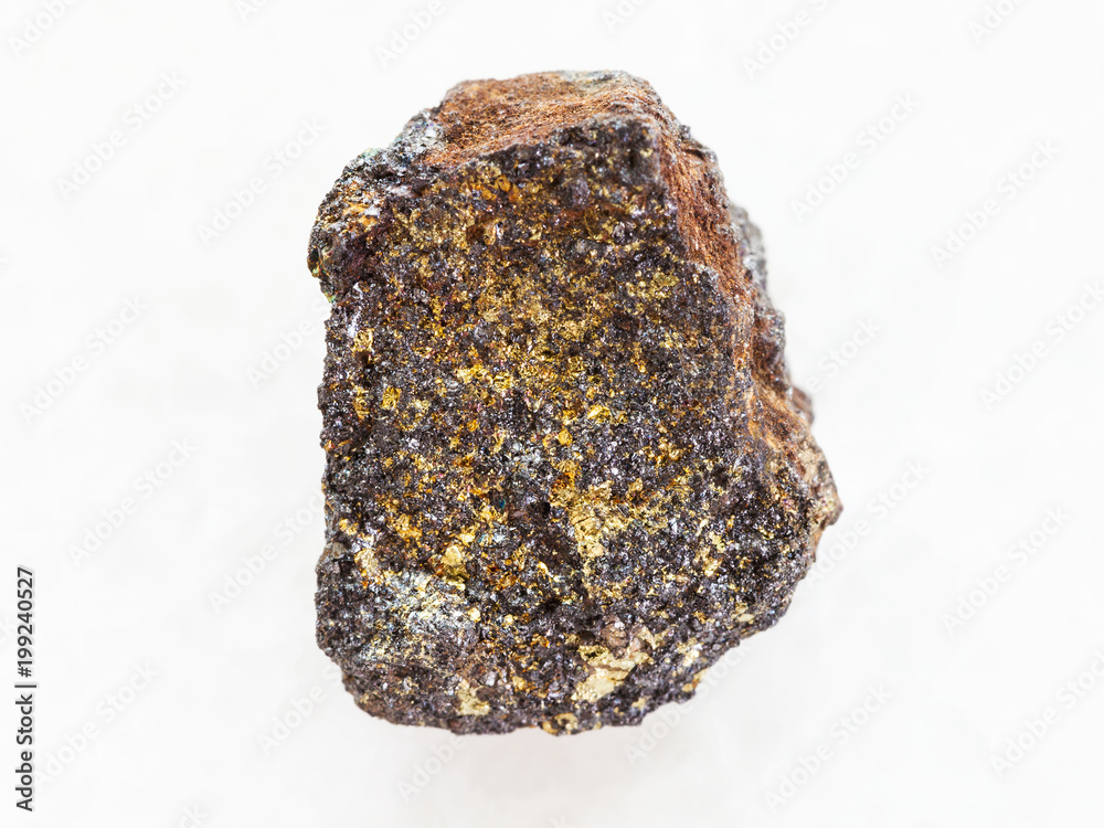 rough magnetite (iron ore) stone on white marble
