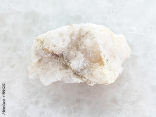 scheelite (tungsten ore) in rough stone on white