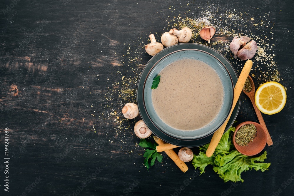 Mashed mushroom soup. Healthy food. Top view. On a black wooden background. Copy space.