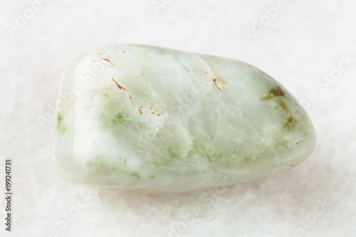 polished vesuvianite gemstone on white marble photo