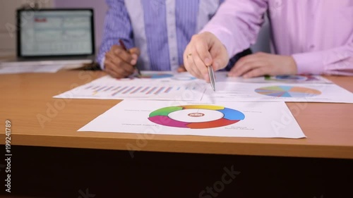 Two businessmen discuss the business project