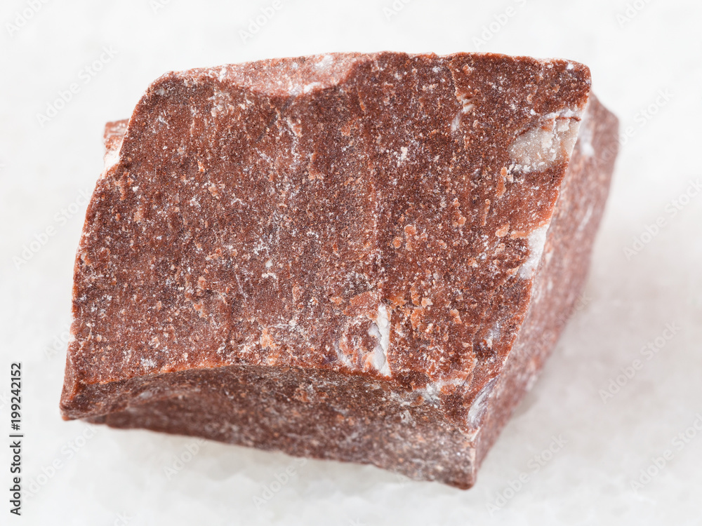piece of rough red marble stone on white piece of rough red marble stone on white