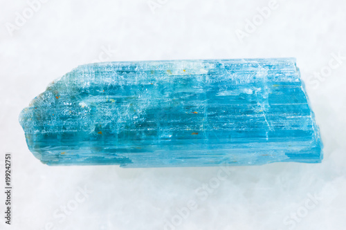 Fotografija rough crystal of aquamarine (blue beryl) on white