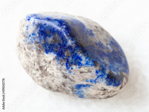 tumbled lazurite stone on white