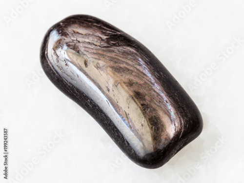 polished Hypersthene gemstone on white photo