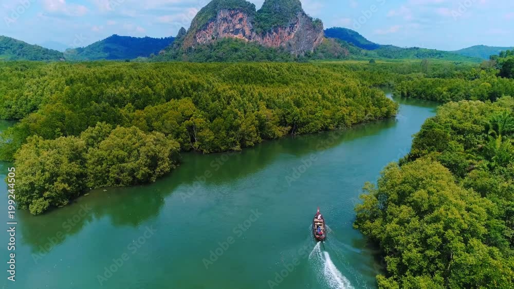 AERIAL. Top view of traditional thai boat at Krabi, Thailand. Mountains on background