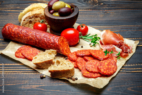 Valokuva Dried organic salami sausage on wooden background