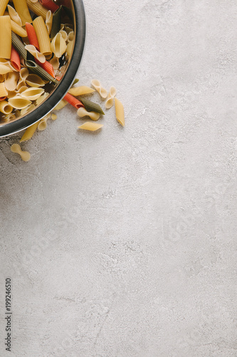 top view of raw pasta in bowl on concrete tabletop