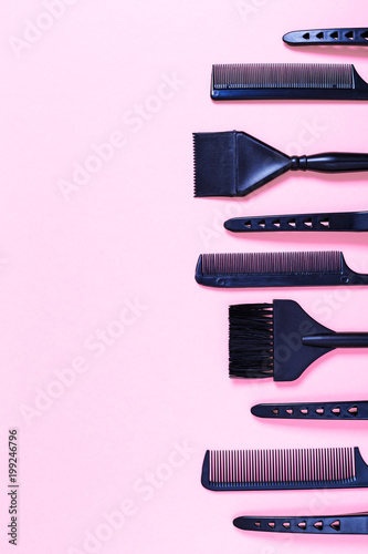 Combs and bleach brushes on pastel colored paper