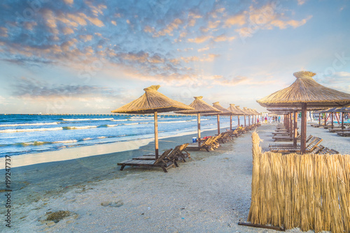 Beach with chairs and umbrella in Mamaia Holiday Resort, black sea coast, Romania. photo