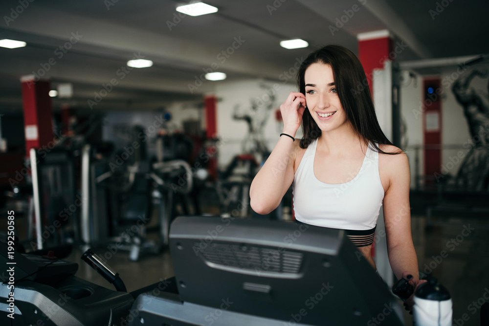 Young pretty girl is trained in the gym