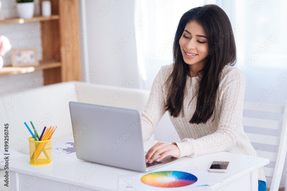 My choice. Joyful glad female freelancer working on laptop and smiling My choice. Joyful glad female freelancer working on laptop and smiling