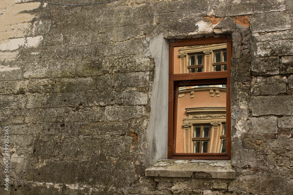 Beauty in reflection concept with window in old slum concrete wall in backstreet Beauty in reflection concept with window in old slum concrete wall in backstreet